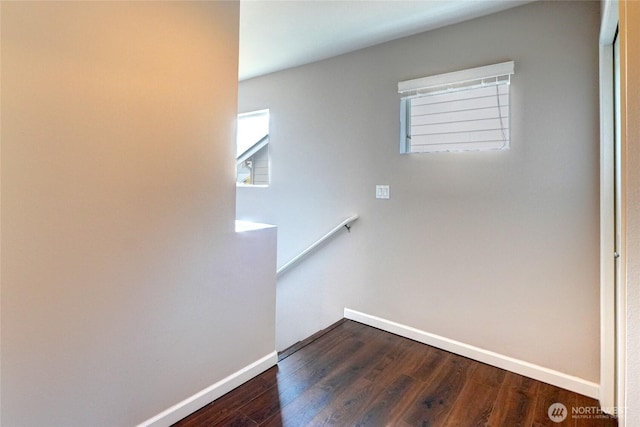 stairway featuring baseboards and wood finished floors