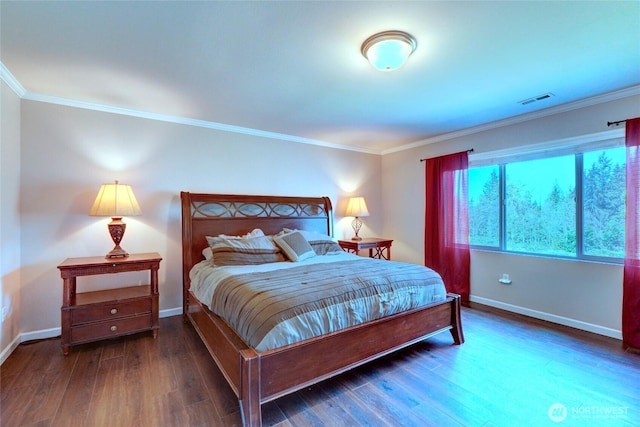 bedroom with crown molding, baseboards, and wood finished floors