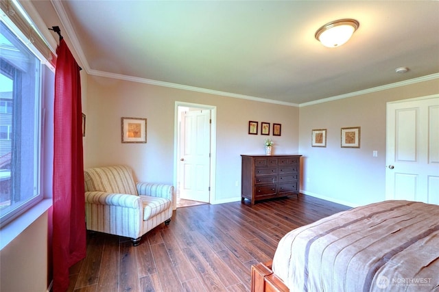 bedroom with ornamental molding, wood finished floors, and baseboards