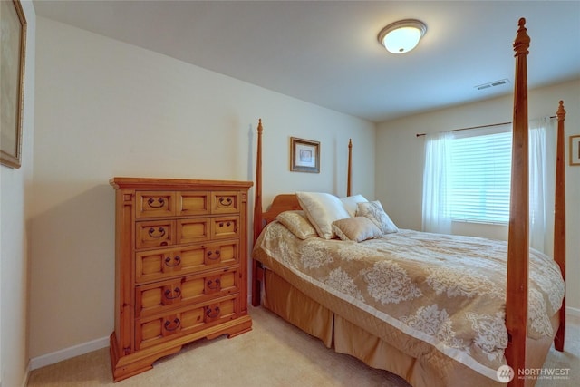 bedroom featuring light carpet and baseboards