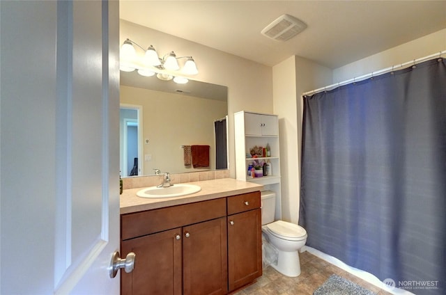 full bath featuring vanity, toilet, and tile patterned floors