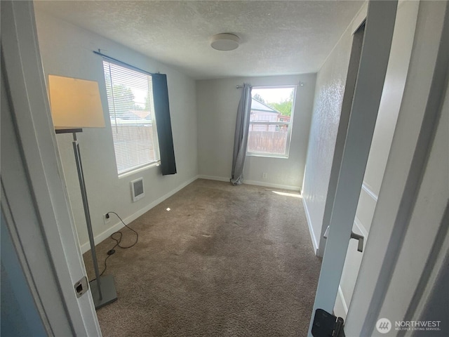105 E 13th Ave, Kennewick, WA 99337 - carpeted spare room with a textured ceiling and baseboards