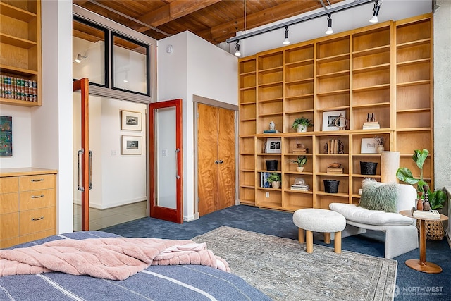 carpeted bedroom with tile patterned floors and wood ceiling