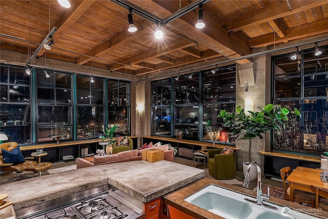 interior space featuring track lighting, a sink, wood ceiling, beamed ceiling, and range