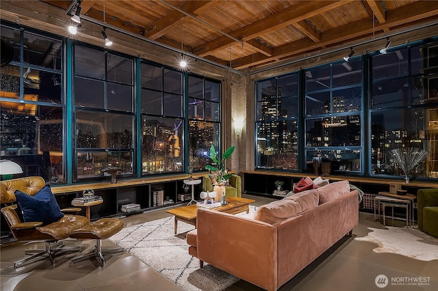 cinema room featuring wood ceiling, beamed ceiling, a dry bar, and track lighting