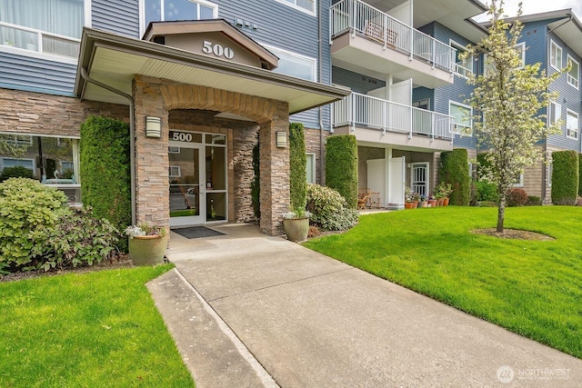 500 Darby Dr Unit A-304, Bellingham, WA 98226 - view of exterior entry featuring stone siding and a lawn