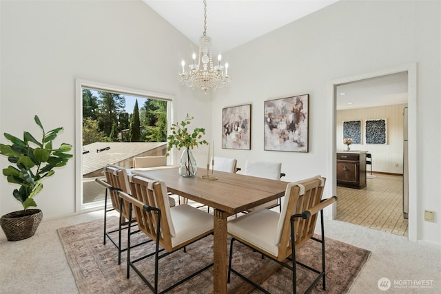 9376 Mercerwood Dr, Mercer Island, WA 98040 - dining area with a chandelier, high vaulted ceiling, baseboards, and light colored carpet