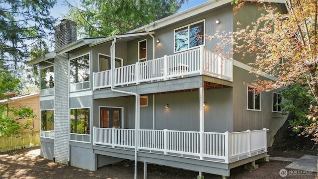 9376 Mercerwood Dr, Mercer Island, WA 98040 - back of house with a chimney, a balcony, and a deck
