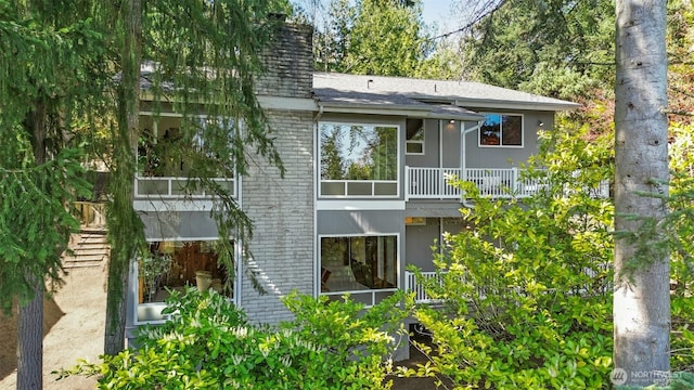 9376 Mercerwood Dr, Mercer Island, WA 98040 - back of property featuring a shingled roof, a balcony, and brick siding