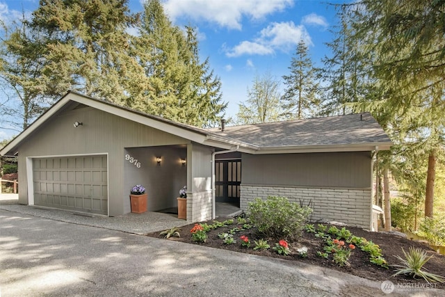 9376 Mercerwood Dr, Mercer Island, WA 98040 - view of front facade with brick siding and an attached garage