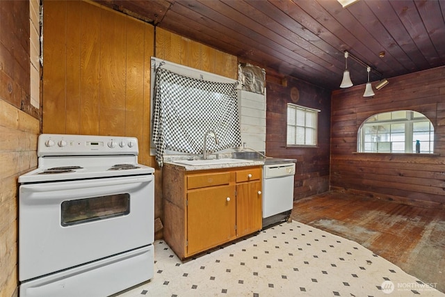 kitchen with wooden walls, wooden ceiling, a sink, and white appliances