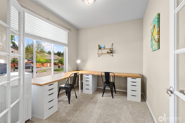 office area with light carpet and baseboards