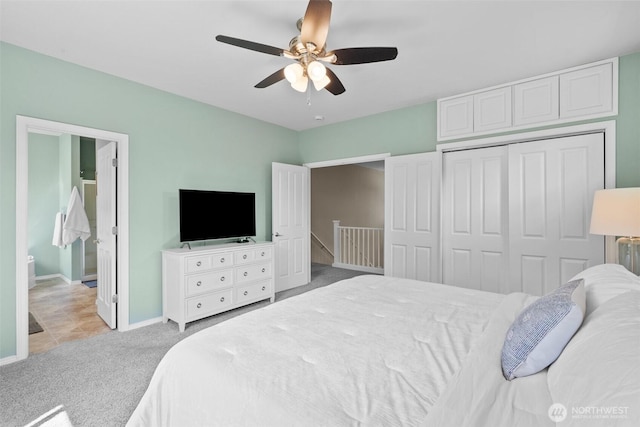 bedroom featuring carpet, a closet, baseboards, a ceiling fan, and connected bathroom