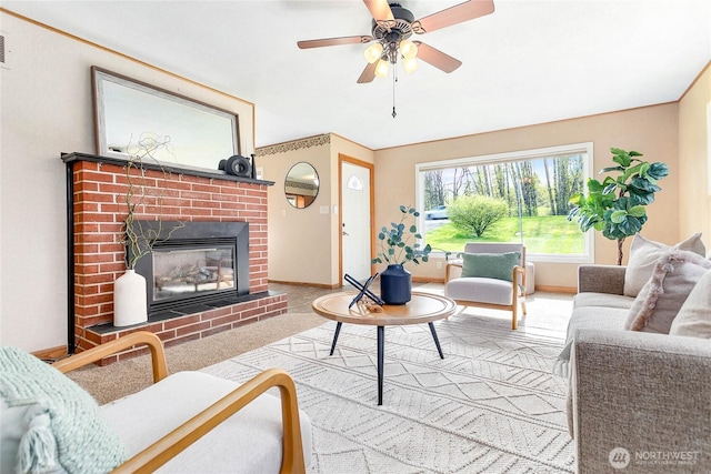 living area featuring visible vents, baseboards, ceiling fan, and a fireplace