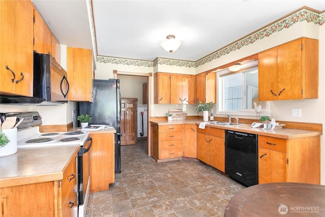 kitchen with light countertops, stone finish flooring, a sink, and black appliances