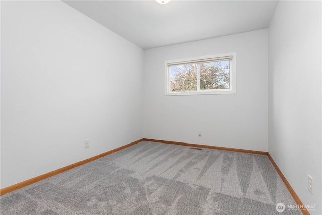 unfurnished room with visible vents, baseboards, and carpet flooring
