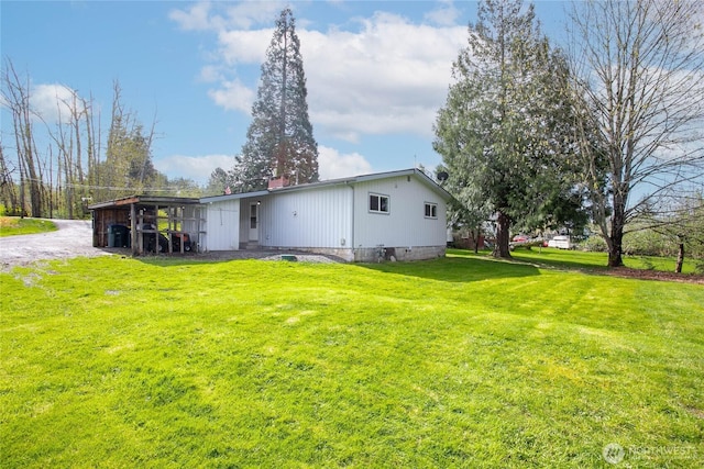 back of property with a lawn