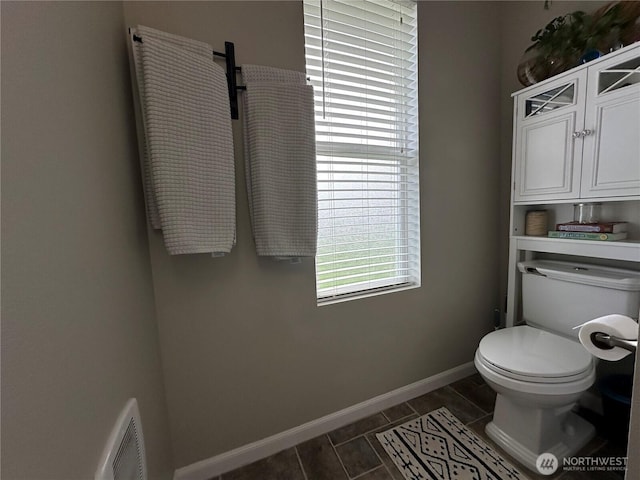bathroom with visible vents, baseboards, and toilet