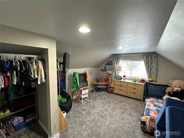bedroom featuring carpet flooring, a textured ceiling, baseboards, and lofted ceiling