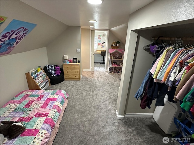 carpeted bedroom with a closet and lofted ceiling