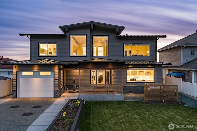 view of front of house with a standing seam roof, metal roof, and concrete driveway