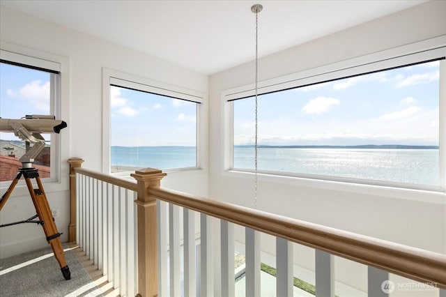 hall featuring a chandelier and a water view