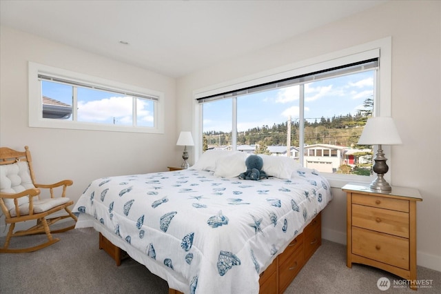 bedroom featuring light carpet and baseboards