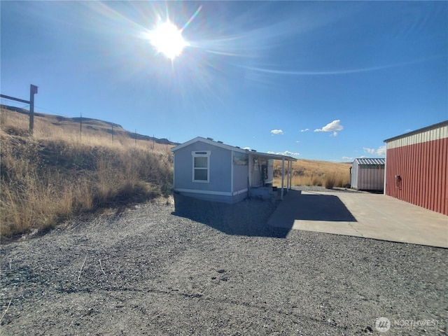 700 Pearl Hill Rd, Bridgeport, WA 98813 - view of outbuilding with driveway and an outbuilding