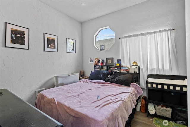411W 1st Ave, Kennewick, WA 99336 - bedroom with wood finished floors and a textured wall