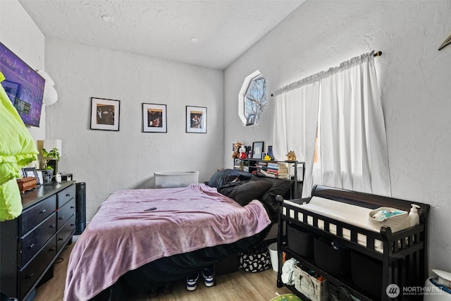 411W 1st Ave, Kennewick, WA 99336 - bedroom with a textured wall and wood finished floors