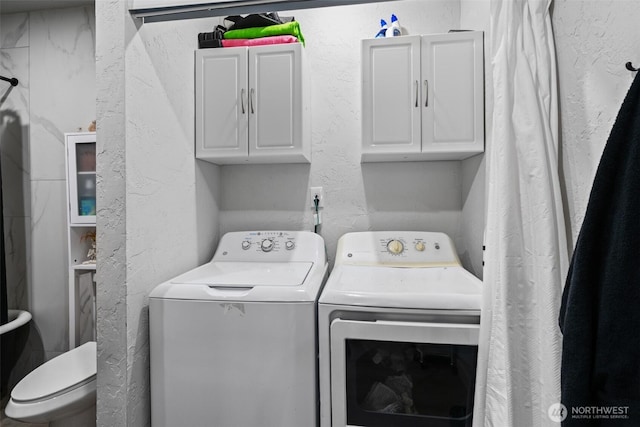 411W 1st Ave, Kennewick, WA 99336 - washroom with washing machine and clothes dryer, a textured wall, and cabinet space