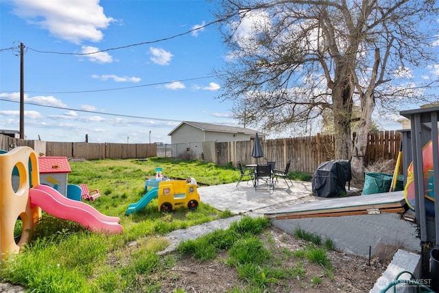 411W 1st Ave, Kennewick, WA 99336 - exterior space with a fenced backyard, a playground, and a patio