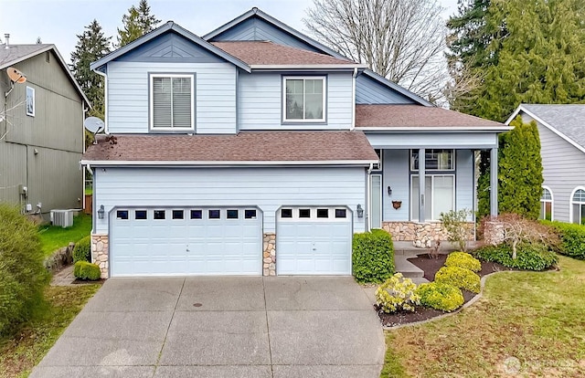 19204 Evergreen Dr, Bonney Lake, WA 98391 - view of front of house featuring concrete driveway, stone siding, a garage, and a shingled roof