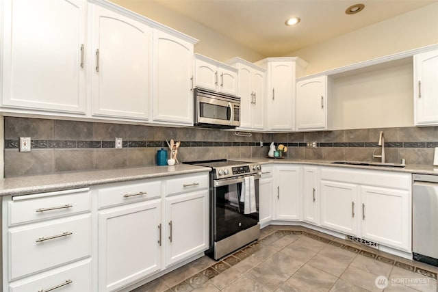19204 Evergreen Dr, Bonney Lake, WA 98391 - kitchen with tasteful backsplash, a sink, white cabinetry, recessed lighting, and stainless steel appliances