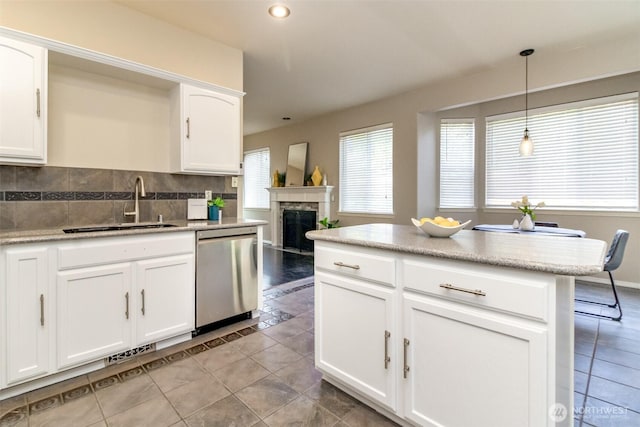 19204 Evergreen Dr, Bonney Lake, WA 98391 - kitchen with decorative light fixtures, dishwasher, a sink, decorative backsplash, and light tile patterned flooring