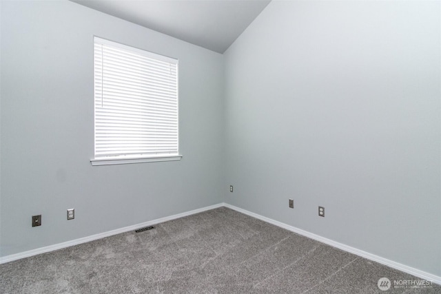 19204 Evergreen Dr, Bonney Lake, WA 98391 - spare room featuring visible vents, baseboards, dark carpet, and lofted ceiling