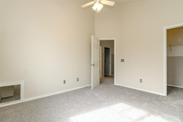 19204 Evergreen Dr, Bonney Lake, WA 98391 - unfurnished bedroom with light carpet, baseboards, and a walk in closet