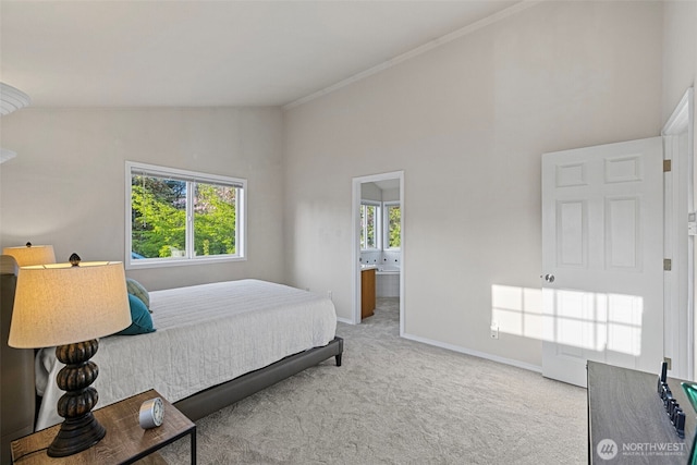 bedroom featuring ensuite bath, lofted ceiling, carpet flooring, baseboards, and crown molding