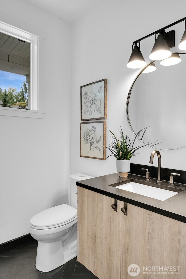 bathroom featuring toilet and vanity