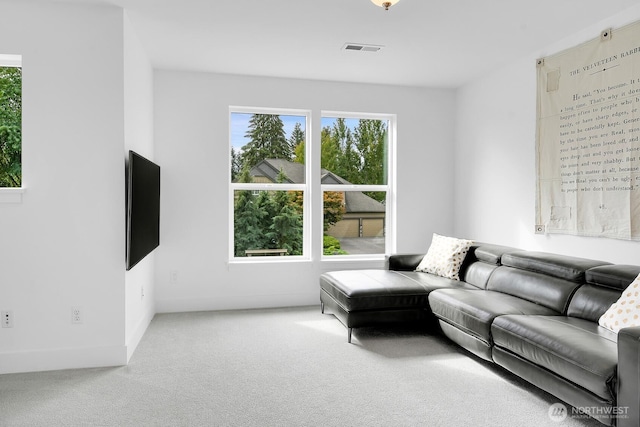 carpeted living room featuring visible vents and baseboards