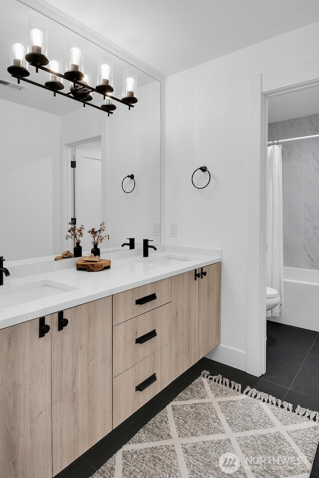 full bathroom featuring double vanity, shower / bath combo, tile patterned floors, visible vents, and a sink