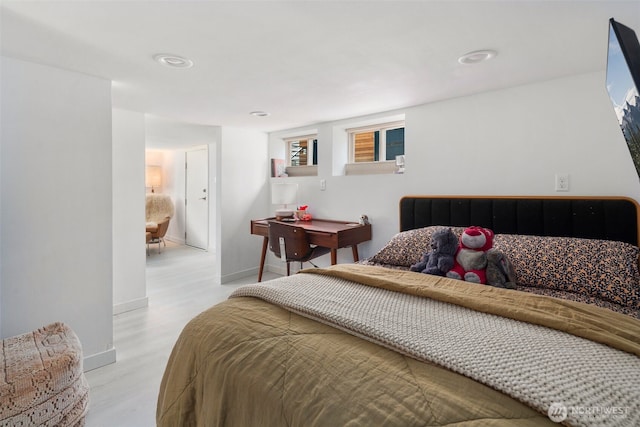 bedroom featuring light wood-style flooring and baseboards