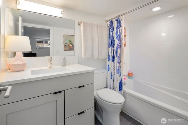bathroom featuring toilet, vanity, shower / tub combo, and recessed lighting