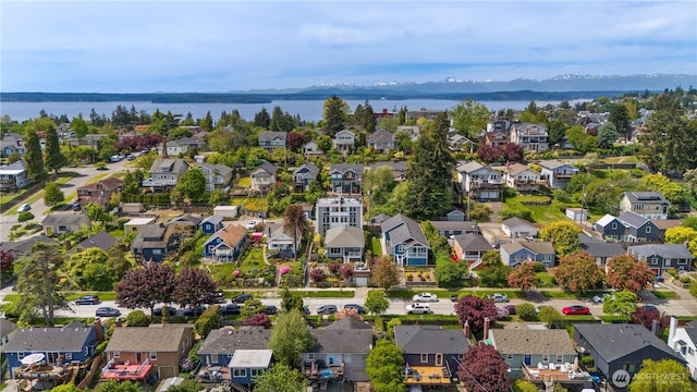 aerial view of residential area featuring a water and mountain view