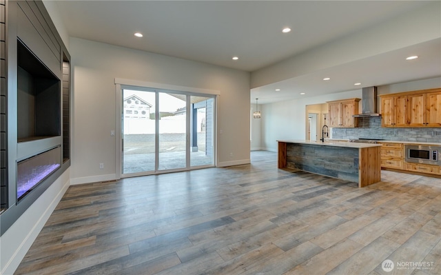 2575 Parkette St SE, East Wenatchee, WA 98802 - kitchen with a sink, stainless steel microwave, recessed lighting, wall chimney range hood, and light countertops