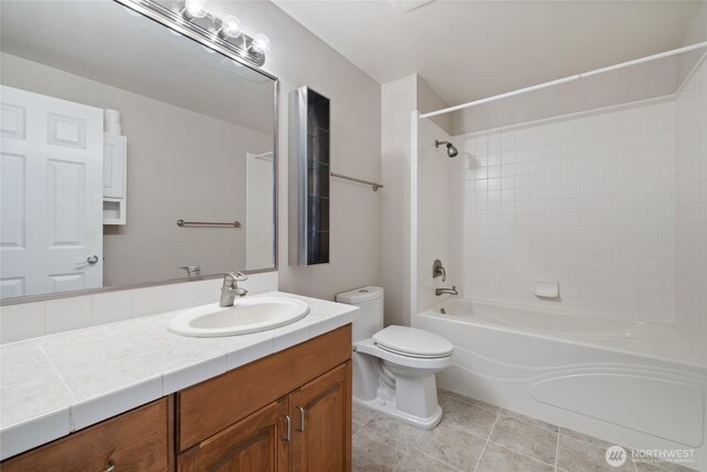 full bathroom with tile patterned floors, vanity, shower / tub combination, and toilet