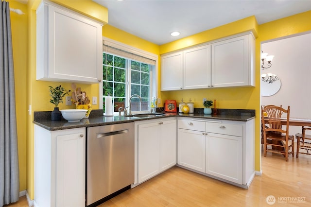 kitchen featuring stainless steel dishwasher, a sink, light wood-type flooring, white cabinetry, and recessed lighting