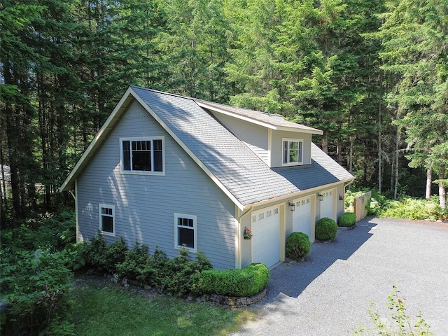 325 Evergreen View Pkwy, Port Angeles, WA 98363 - view of property exterior with a wooded view and gravel driveway