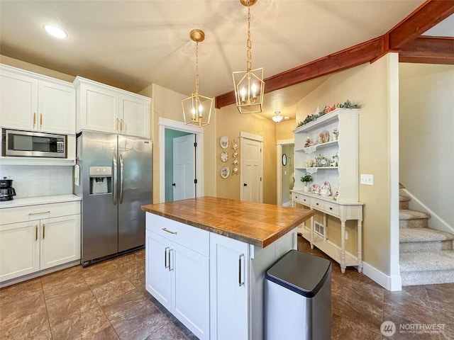 325 Evergreen View Pkwy, Port Angeles, WA 98363 - kitchen with tasteful backsplash, butcher block counters, white cabinetry, stainless steel appliances, and a notable chandelier