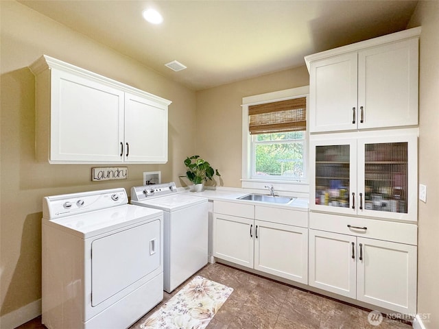 325 Evergreen View Pkwy, Port Angeles, WA 98363 - washroom featuring separate washer and dryer, visible vents, a sink, and cabinet space